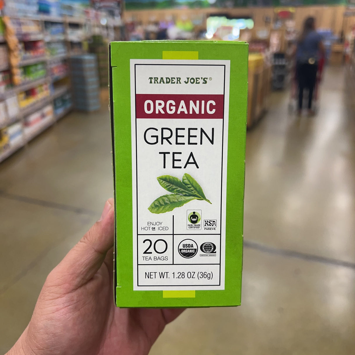 Trader Joe's Organic Green Tea 20 Tea Bags 1.28 oz bright green box front, Enjoy Hot or Iced, Fair Trade Certified, KSA Pareve, USDA Organic, Certified Organic globe logo, 20 Tea Bags, Net Wt. 1.28 oz 36g, green tea leaf illustration