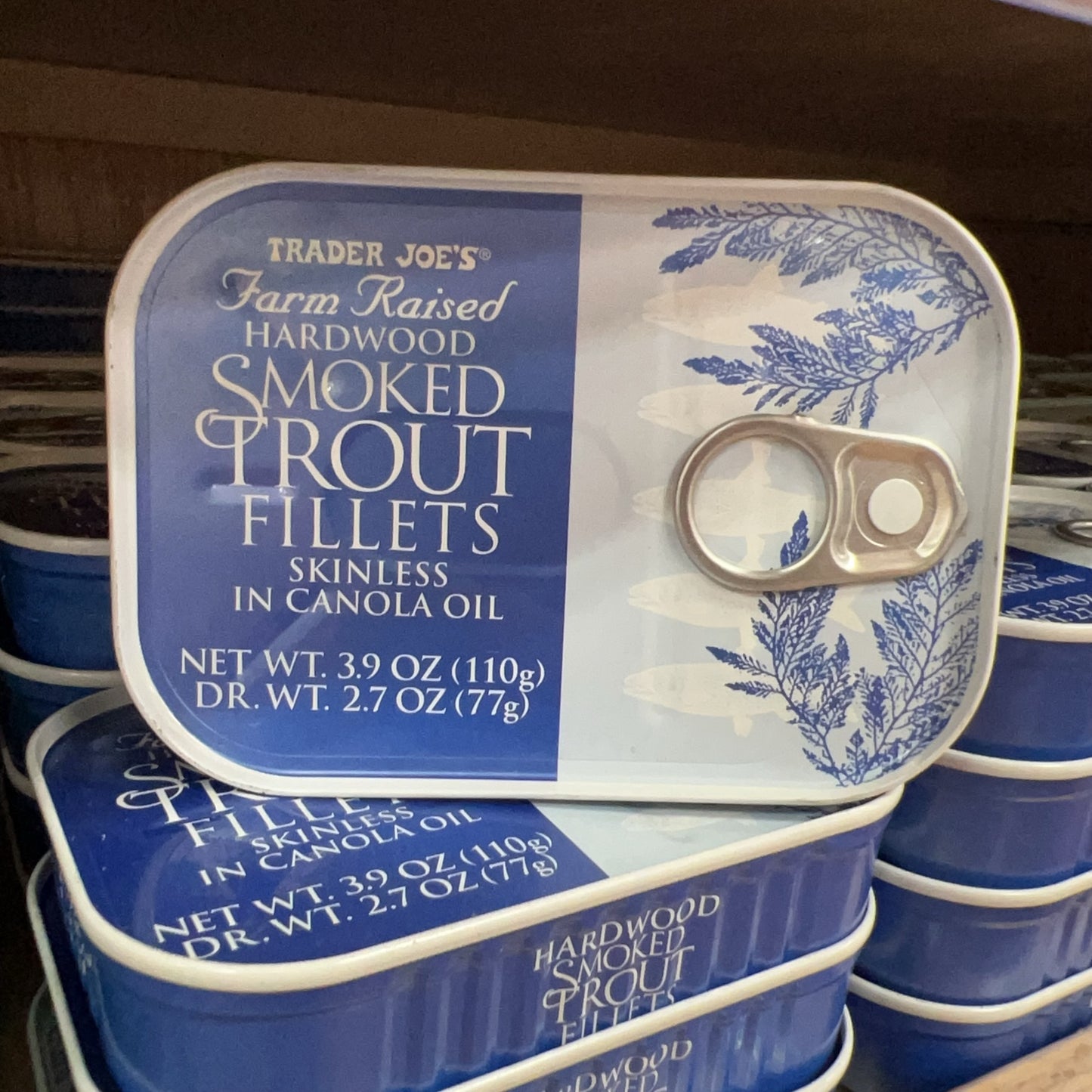 Trader Joe's Hardwood Smoked Trout Fillets tins displayed on store shelf
