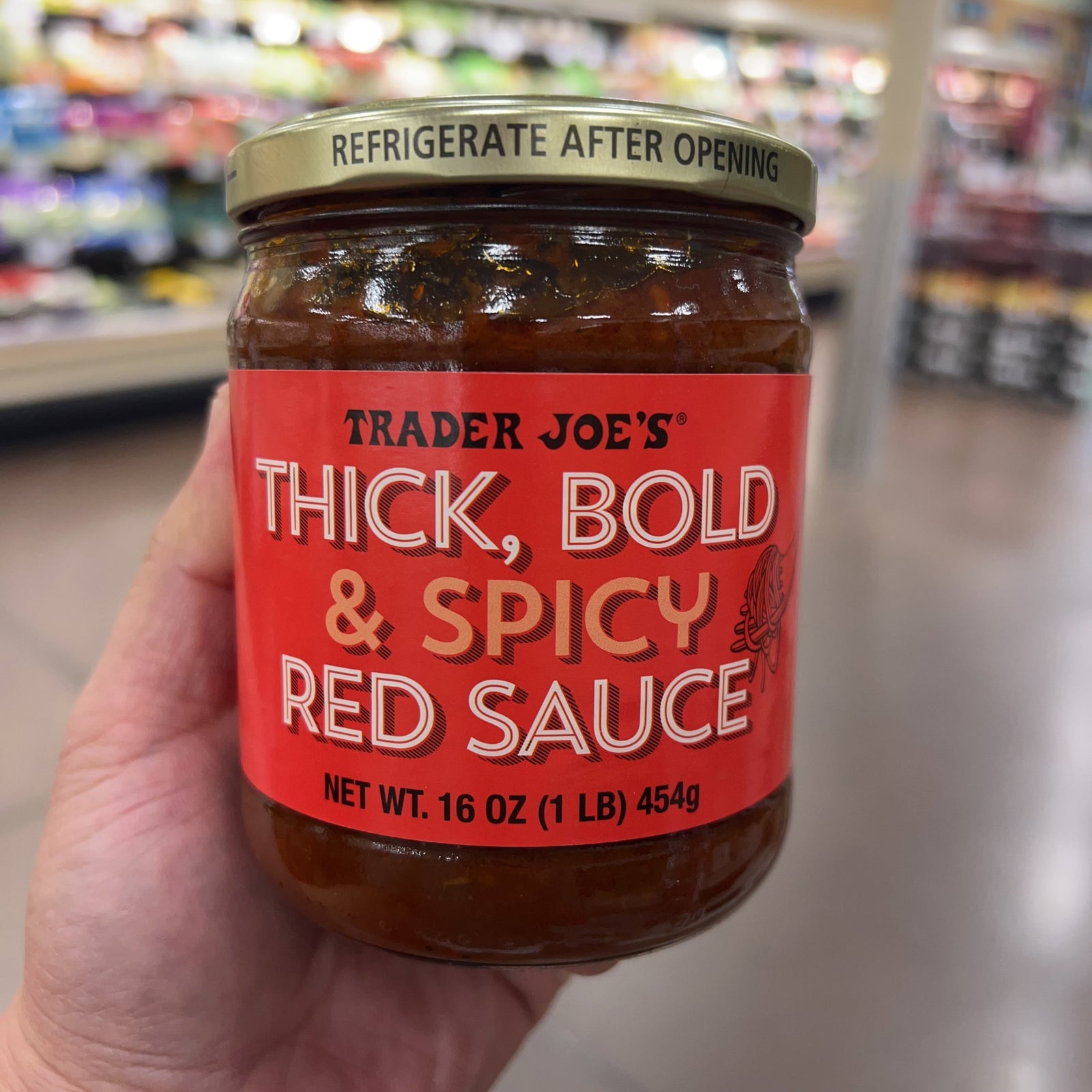 Trader Joe's Thick Bold and Spicy Red Sauce 16 oz jar with deep red tomato sauce visible through glass