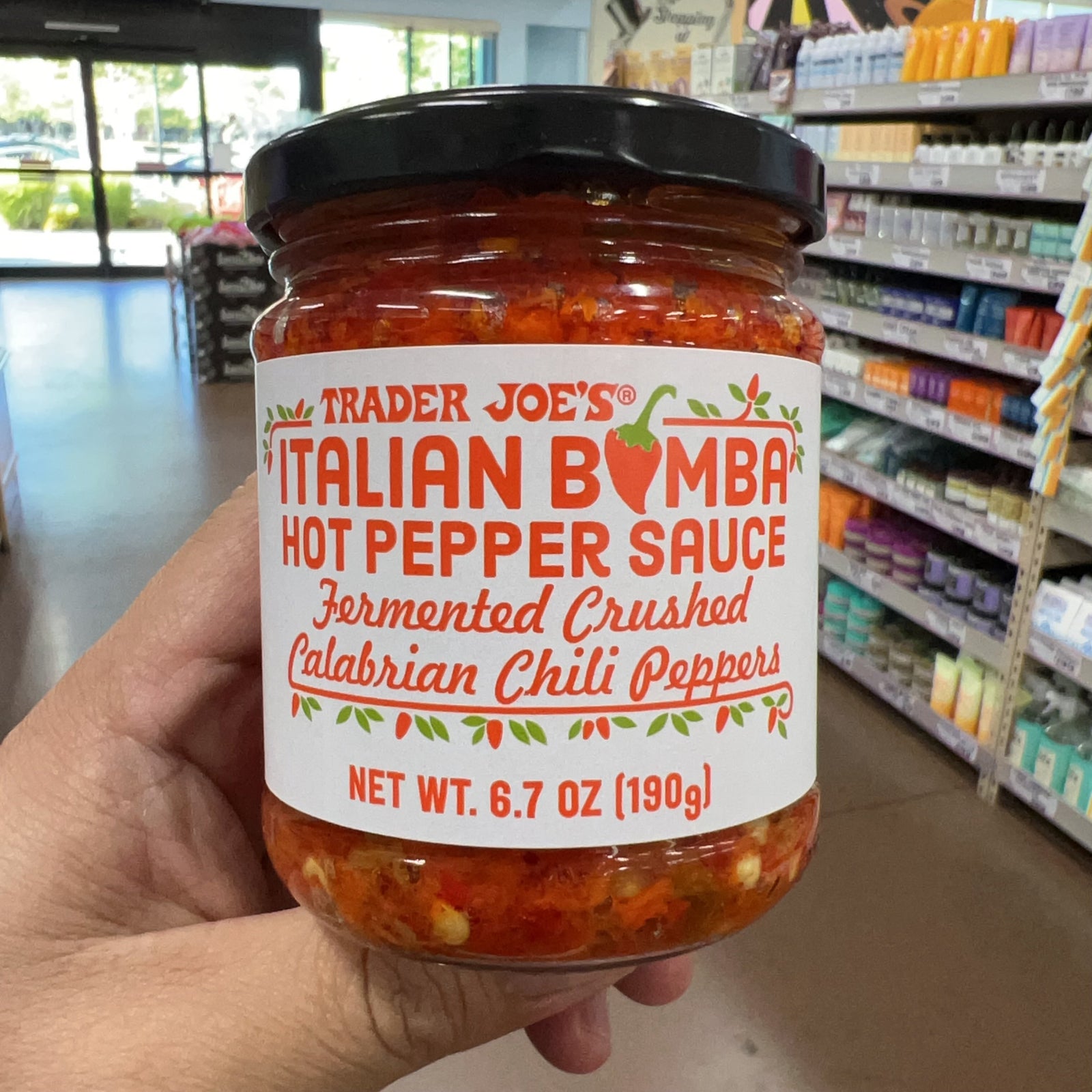 Trader Joe's Italian Bomba Hot Pepper Sauce 6.7 oz jar with red chili pepper sauce visible through glass