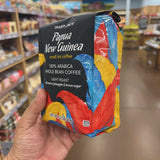 Trader Joe's Papua New Guinea Small Lot Coffee — front of bag, 100% Arabica Whole Bean Coffee, Light Roast, with notes of pineapple & brown sugar, net wt 12 oz (340g), Kosher Pareve (KSA), colorful tropical bird feather design on black bag