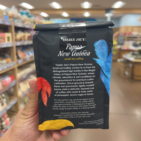 Trader Joe's Papua New Guinea Small Lot Coffee — side view of bag showing one-way degassing valve on top, colorful feather design on sides