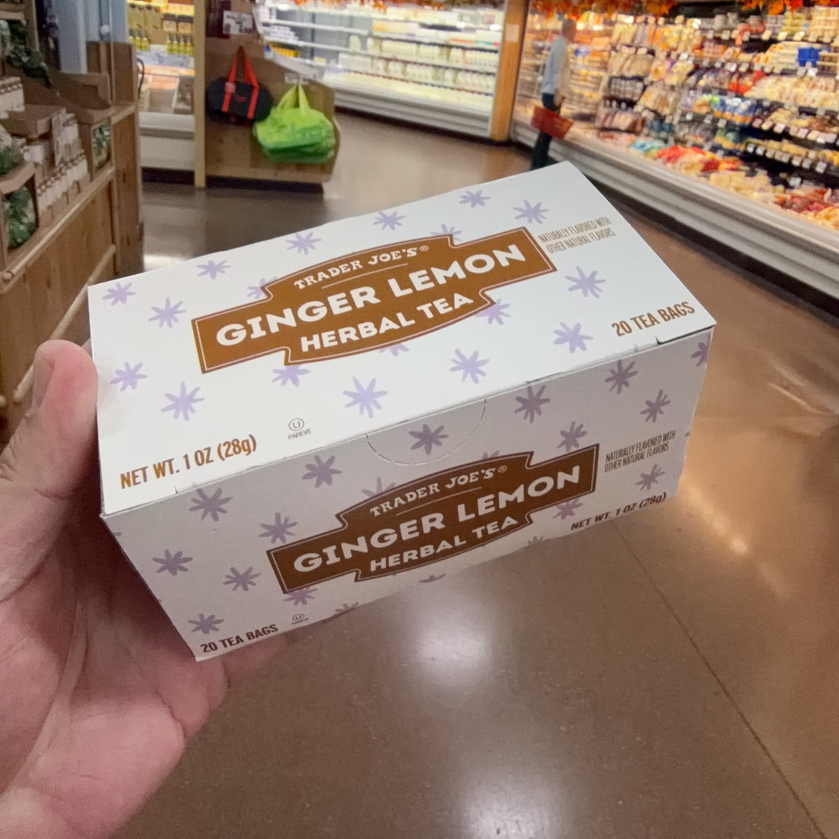 Angled view of Trader Joe's Ginger Lemon Herbal Tea box showing top and front panels.