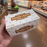 Angled view of Trader Joe's Ginger Lemon Herbal Tea box showing top and front panels.