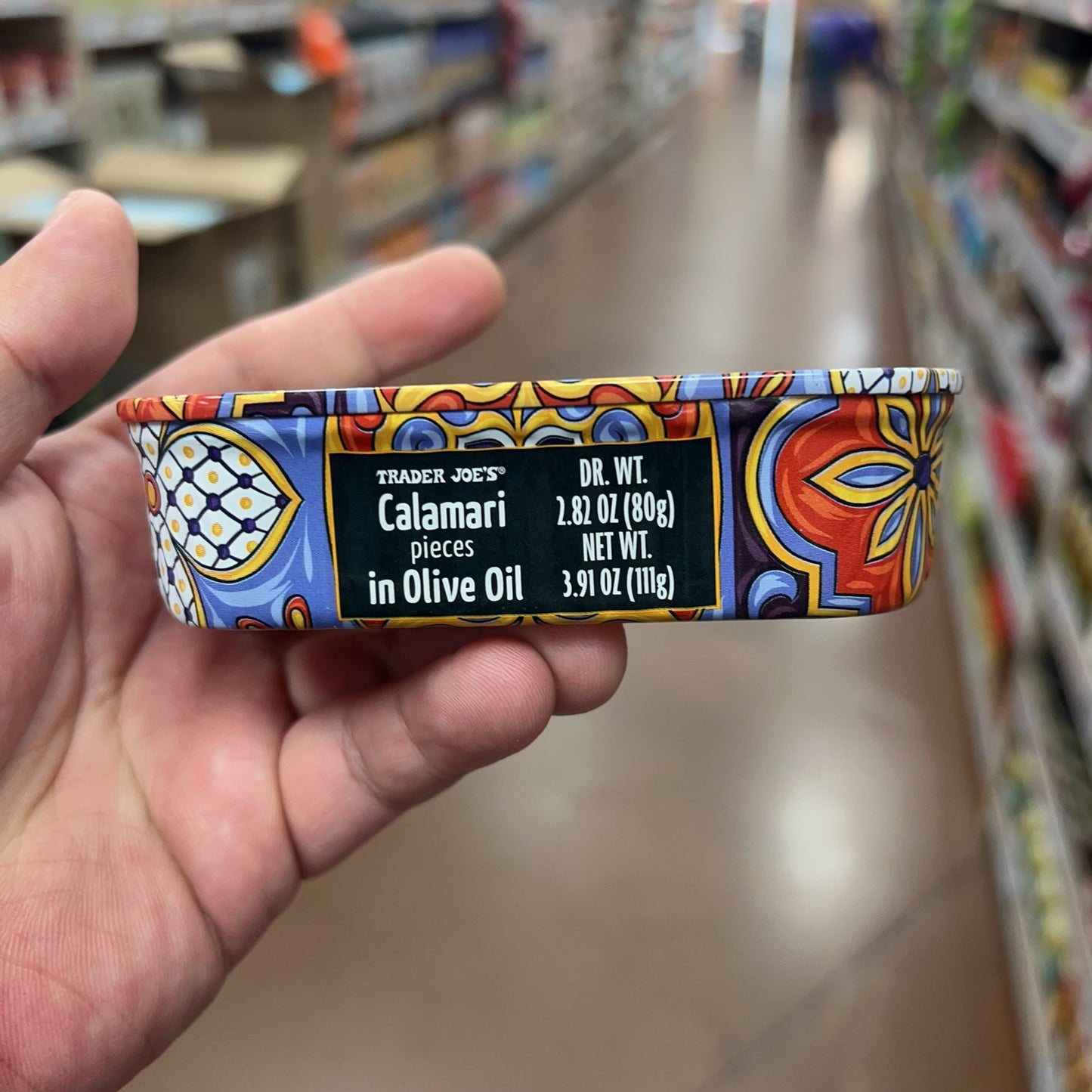 Trader Joe's Calamari Pieces in Olive Oil side label showing drained and net weight