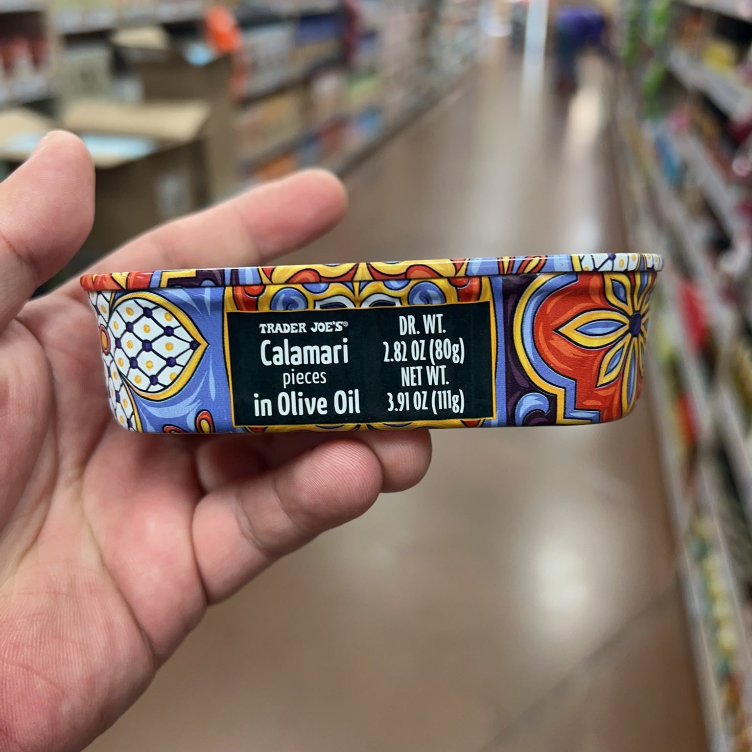 Trader Joe's Calamari Pieces in Olive Oil side label showing drained and net weight