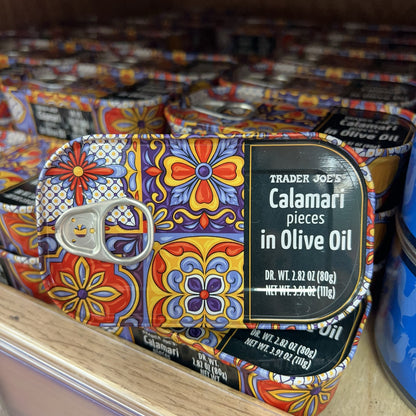 Trader Joe's Calamari Pieces in Olive Oil tins on store shelf