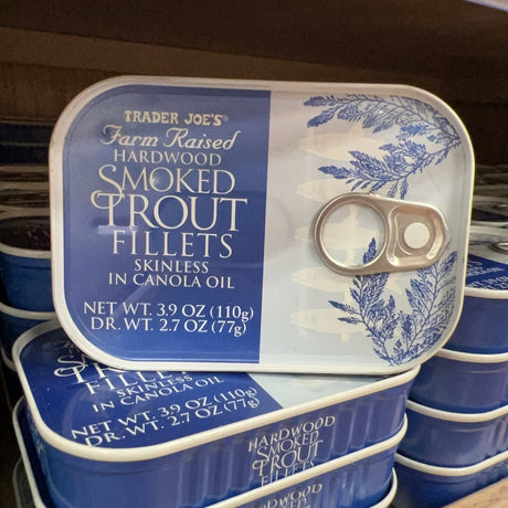 Trader Joe's Hardwood Smoked Trout Fillets tins displayed on store shelf