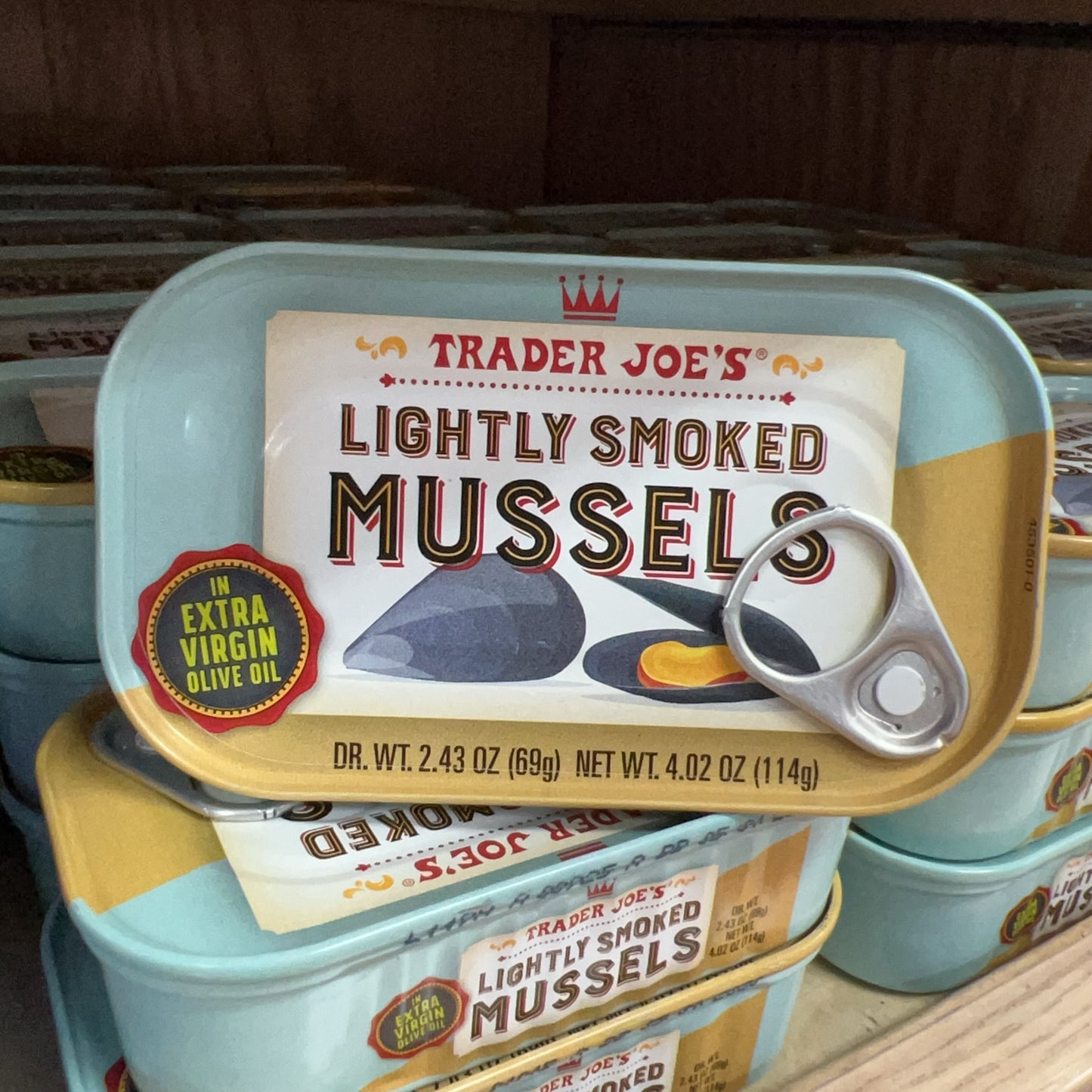 Trader Joe's Lightly Smoked Mussels tins displayed on store shelf
