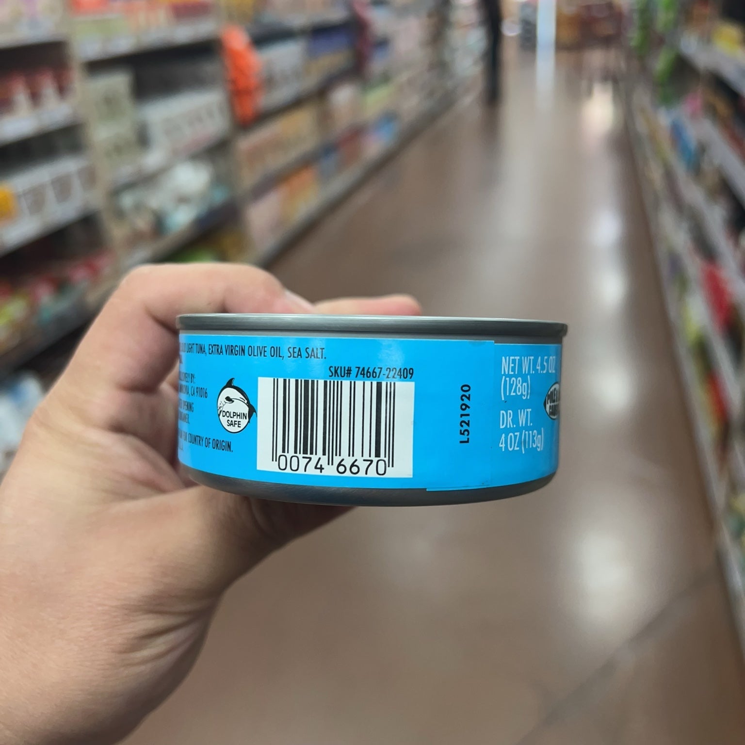 Trader Joe's Solid Light Yellowfin Tuna cans displayed on store shelf
