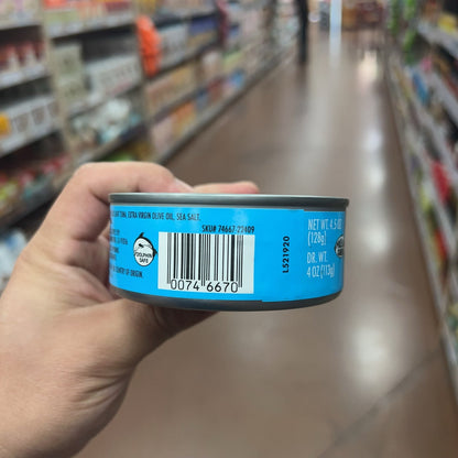 Trader Joe's Solid Light Yellowfin Tuna cans displayed on store shelf